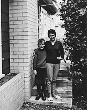 A young Steve standing with his mother